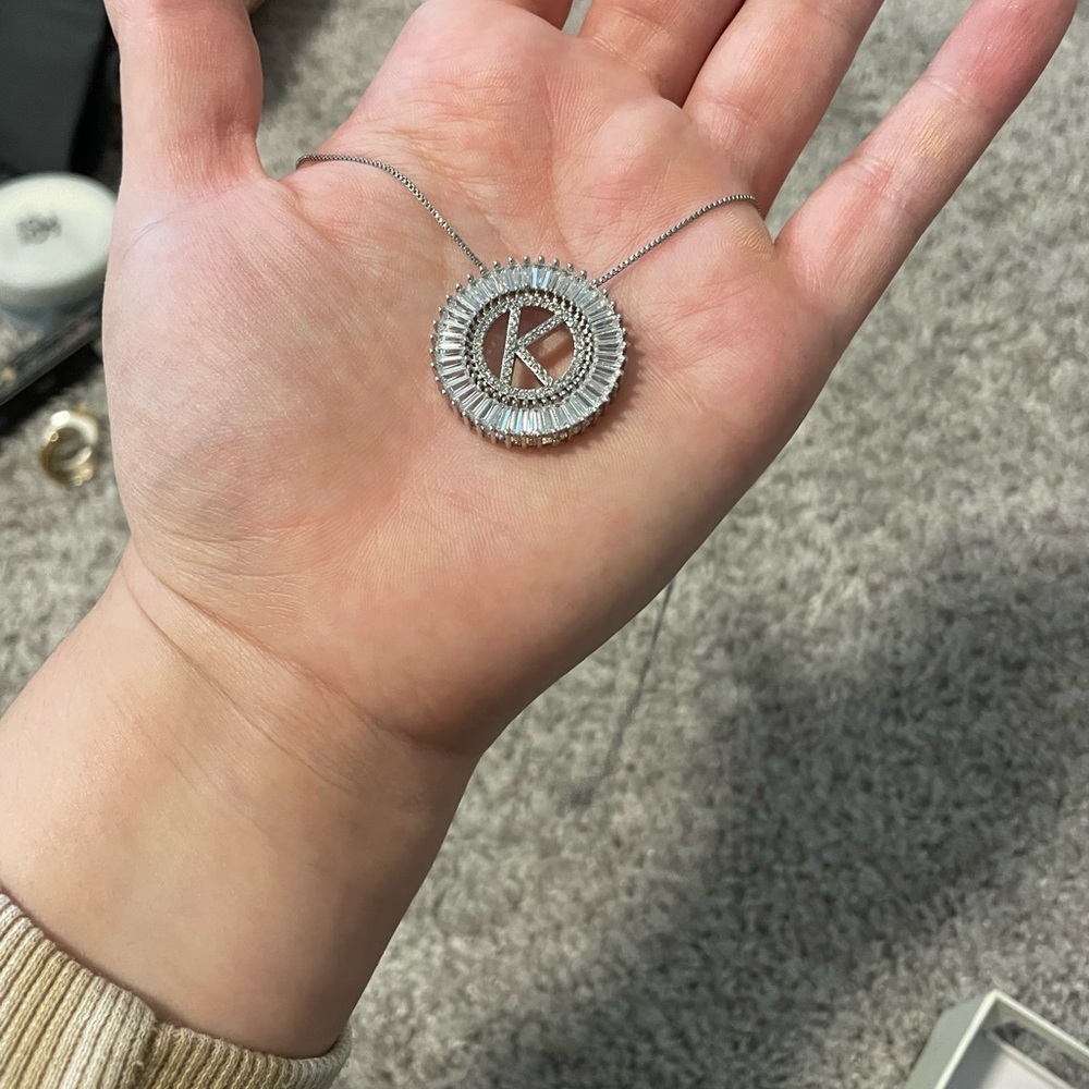 Silver K necklace.